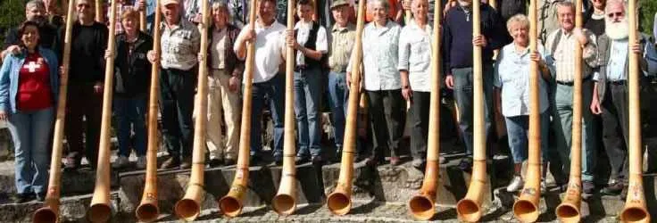 Alphorn players in traditional Swiss clothing