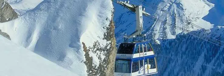 Mountain cable car in a snowy Swiss alpine landscape