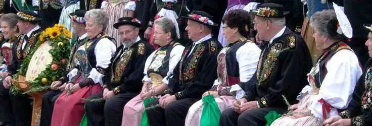 People in traditional Swiss costumes at a festival